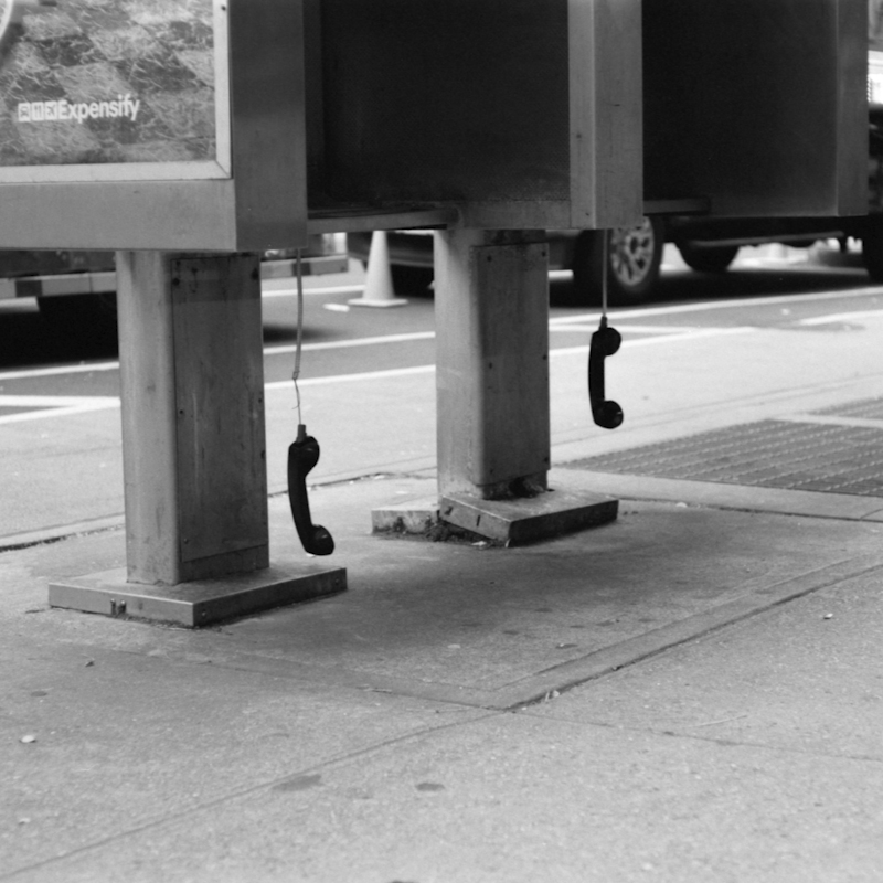 phone receivers hanging from outdoor phone